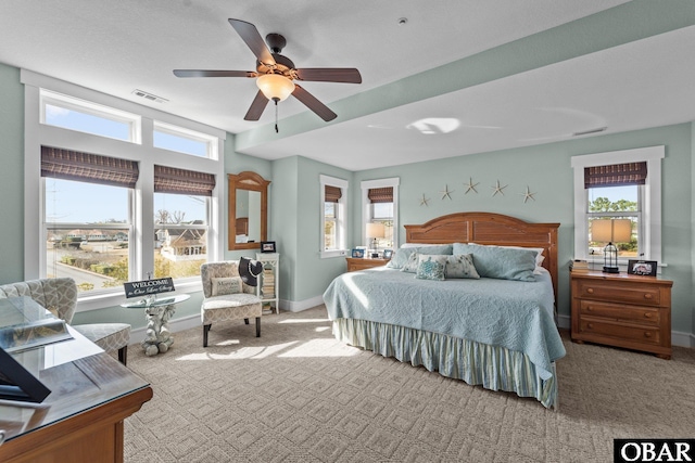 bedroom with carpet floors, multiple windows, and visible vents