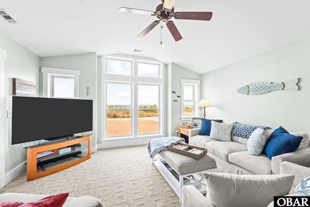 living area with ceiling fan, light carpet, visible vents, baseboards, and vaulted ceiling