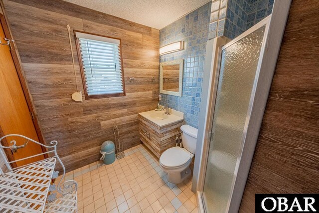 24143 Ocean Dr Lot 4, Rodanthe, NC 27968 - full bathroom featuring toilet, a shower stall, vanity, tile patterned flooring, and a textured ceiling
