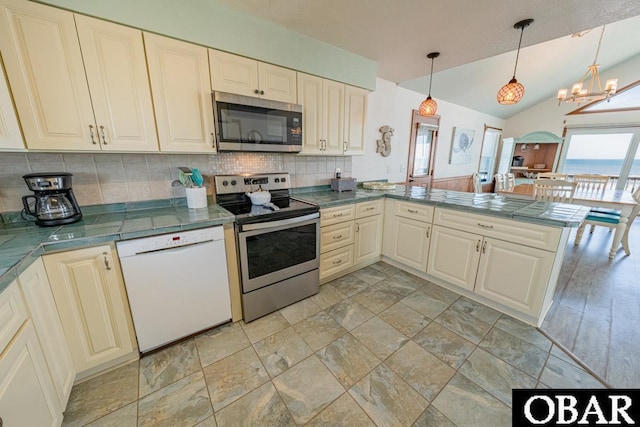 24143 Ocean Dr Lot 4, Rodanthe, NC 27968 - kitchen with stainless steel appliances, backsplash, a chandelier, a peninsula, and vaulted ceiling