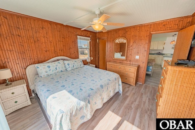 24143 Ocean Dr Lot 4, Rodanthe, NC 27968 - bedroom with wood walls, light wood finished floors, a ceiling fan, ensuite bathroom, and crown molding