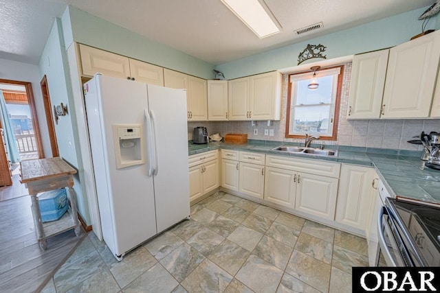 24143 Ocean Dr Lot 4, Rodanthe, NC 27968 - kitchen featuring white refrigerator with ice dispenser, a sink, healthy amount of natural light, and tasteful backsplash