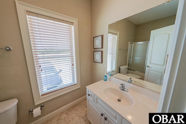22097 Sea Gull St Lot 7, Rodanthe, NC 27968 - bathroom featuring toilet, combined bath / shower with glass door, vanity, and baseboards