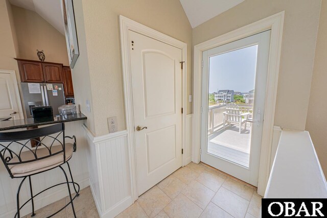 22097 Sea Gull St Lot 7, Rodanthe, NC 27968 - entryway featuring vaulted ceiling and a wainscoted wall