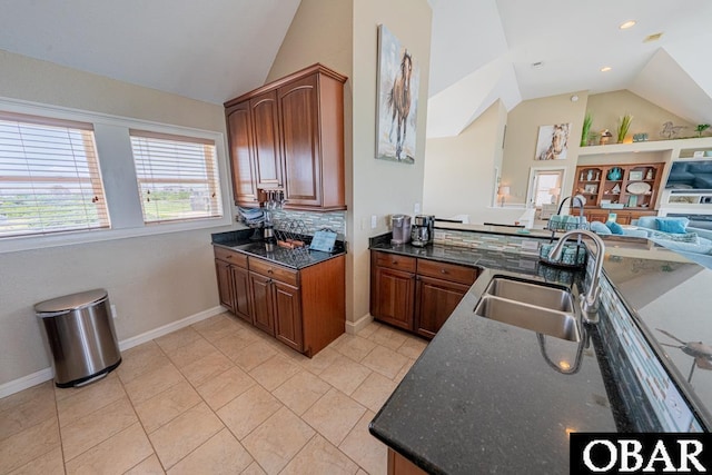 22097 Sea Gull St Lot 7, Rodanthe, NC 27968 - kitchen featuring vaulted ceiling, a sink, open floor plan, brown cabinetry, and baseboards