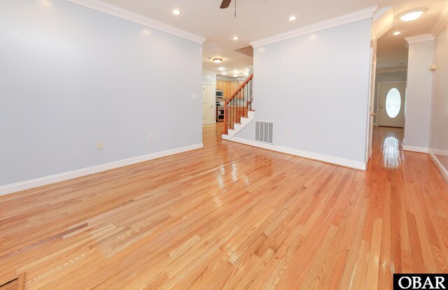 892 S Mills Rd Lot 10, Moyock, NC 27958 - unfurnished living room featuring stairs, light wood-type flooring, ornamental molding, baseboards, and visible vents