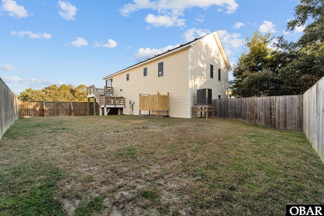 back of property featuring a fenced backyard, stairway, and a yard