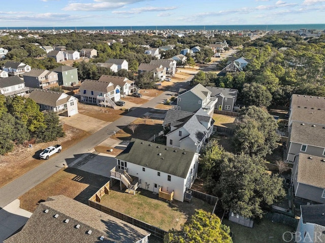 drone / aerial view featuring a residential view and a water view