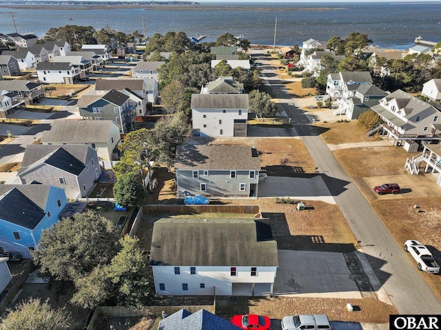 drone / aerial view with a water view and a residential view