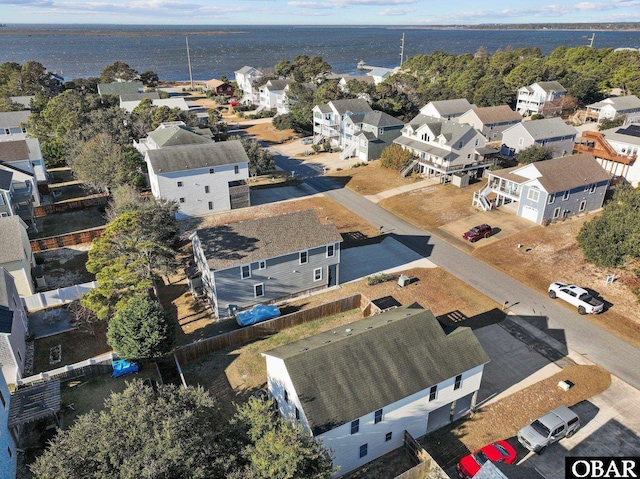 bird's eye view featuring a water view and a residential view