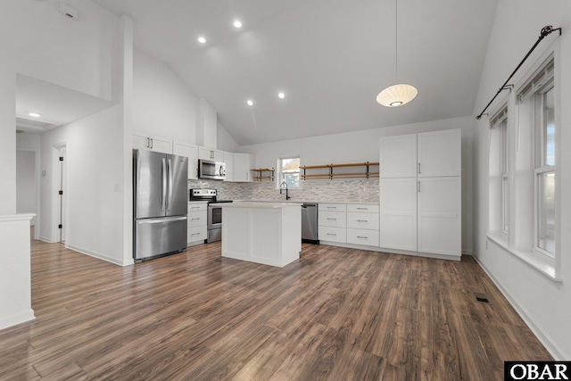 kitchen featuring open shelves, white cabinetry, appliances with stainless steel finishes, and light countertops