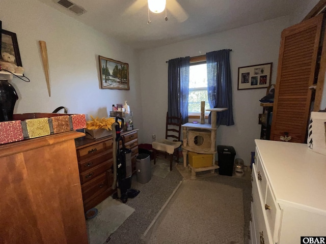 office area with carpet, visible vents, and ceiling fan