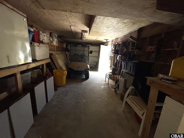 basement featuring a garage and a workshop area