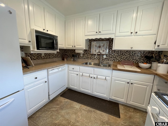 kitchen featuring tasteful backsplash, white appliances, light countertops, white cabinetry, and a sink