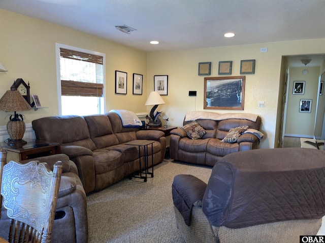 carpeted living area with recessed lighting and visible vents