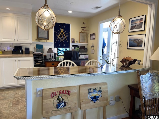 kitchen with visible vents, white cabinets, recessed lighting, and hanging light fixtures