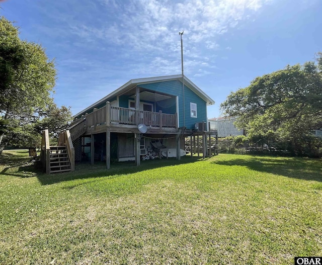 rear view of property with a lawn, a wooden deck, and stairway