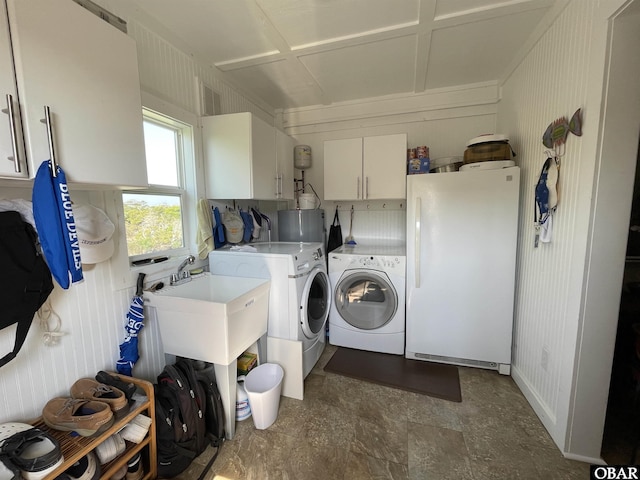 clothes washing area featuring cabinet space, visible vents, washing machine and dryer, and a sink