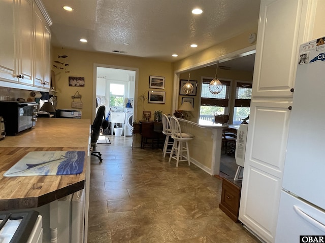 interior space featuring a wealth of natural light, recessed lighting, and freestanding refrigerator
