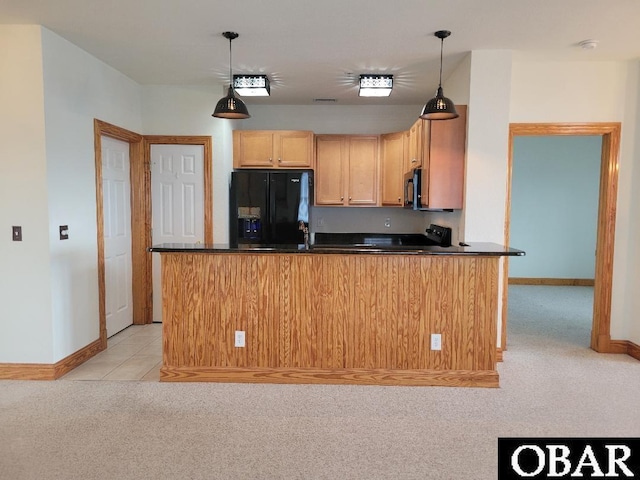 kitchen featuring dark countertops, light carpet, baseboards, and black appliances