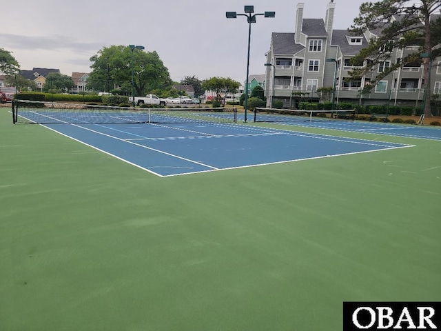 view of tennis court with fence