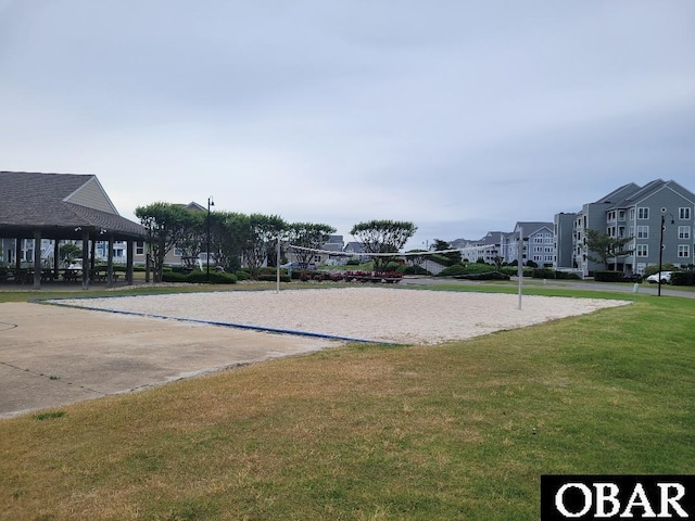 view of home's community featuring a yard and volleyball court