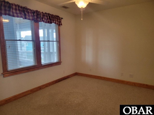 empty room with carpet, baseboards, and a ceiling fan