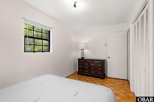 520 W Ocean Acres Dr Lot 36, Kill Devil Hills, NC 27948 - bedroom featuring a closet and a textured ceiling