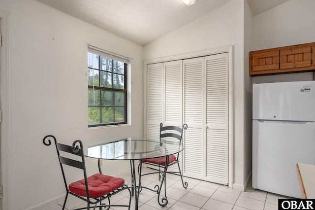 520 W Ocean Acres Dr Lot 36, Kill Devil Hills, NC 27948 - dining area with light tile patterned floors, lofted ceiling, and a textured ceiling