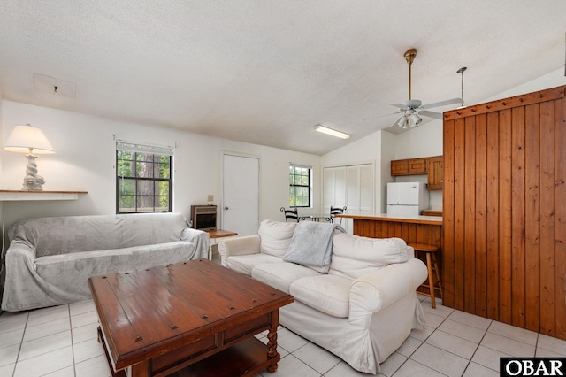 520 W Ocean Acres Dr Lot 36, Kill Devil Hills, NC 27948 - living area with lofted ceiling, light tile patterned floors, healthy amount of natural light, a textured ceiling, and ceiling fan