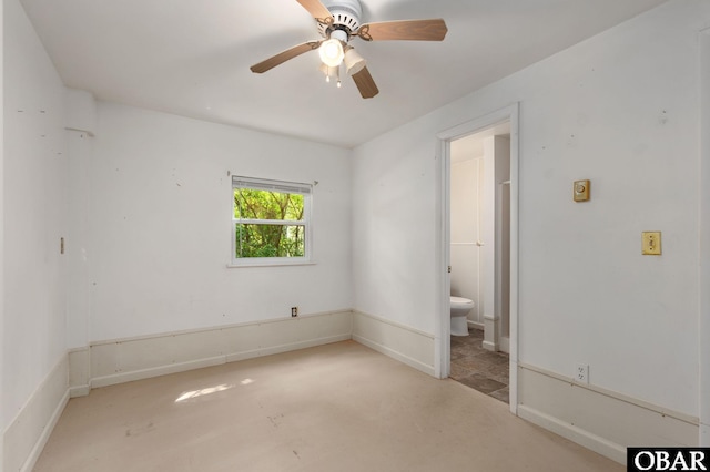 520 W Ocean Acres Dr Lot 36, Kill Devil Hills, NC 27948 - unfurnished bedroom with connected bathroom, a ceiling fan, and concrete flooring