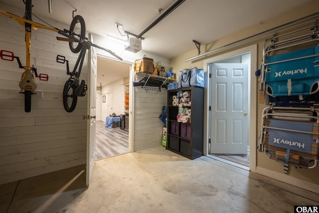 1108 Cambridge Rd Unit 307-A, Kill Devil Hills, NC 27948 - garage with wood walls and a garage door opener