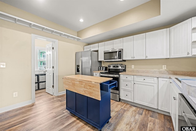 1108 Cambridge Rd Unit 307-A, Kill Devil Hills, NC 27948 - kitchen with stainless steel appliances, wood counters, light wood-style flooring, white cabinetry, and recessed lighting