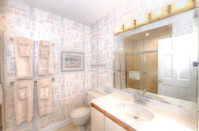 full bathroom with a textured ceiling, a shower stall, vanity, and wallpapered walls