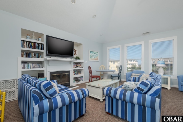 carpeted living area featuring baseboards, visible vents, and a glass covered fireplace