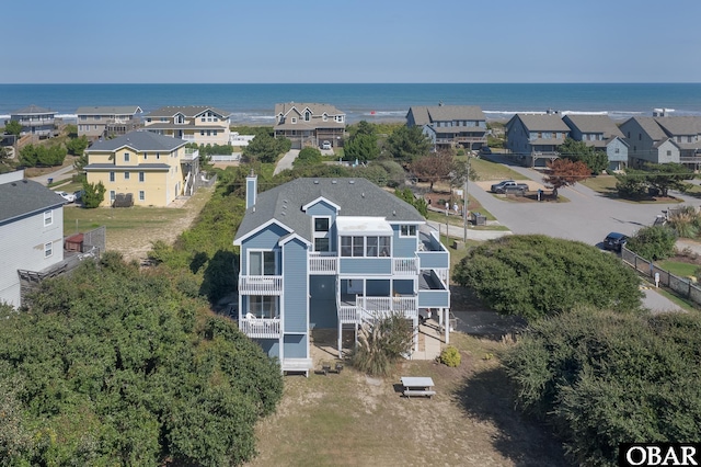 birds eye view of property with a residential view and a water view