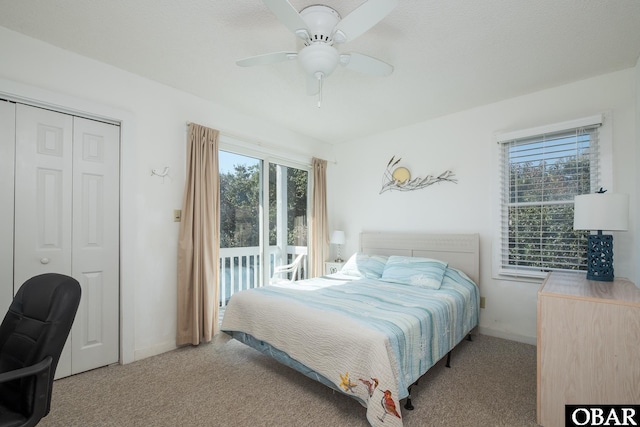 carpeted bedroom featuring a closet, a ceiling fan, access to outside, and baseboards