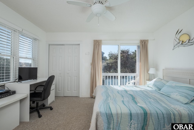 bedroom featuring access to exterior, a ceiling fan, a closet, and light colored carpet