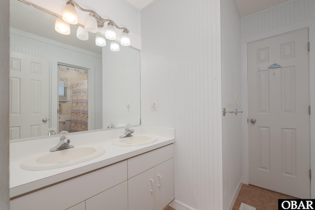 bathroom with curtained shower, double vanity, a sink, and tile patterned floors