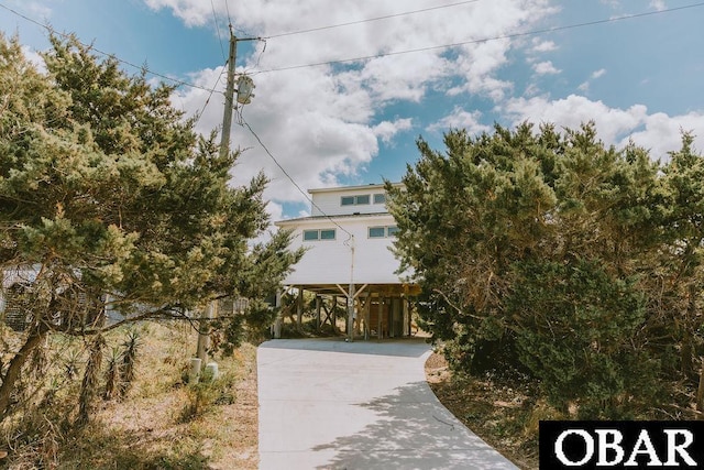 view of front facade featuring concrete driveway and a carport