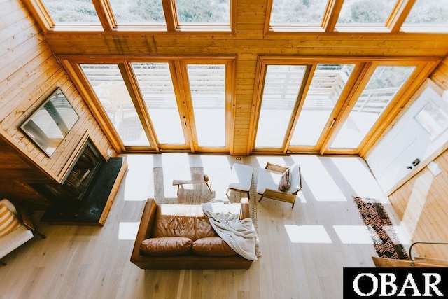 living area with wood finished floors and wood walls