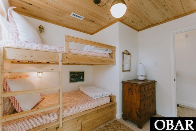 carpeted bedroom with visible vents and wood ceiling