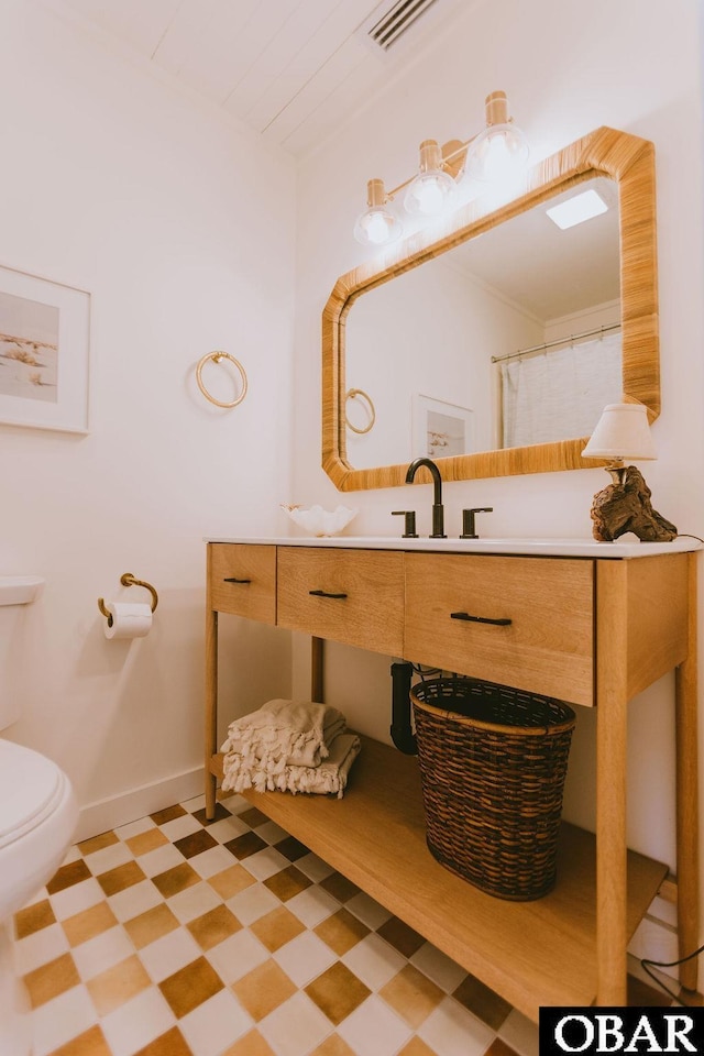 full bath with tile patterned floors, vanity, baseboards, toilet, and visible vents
