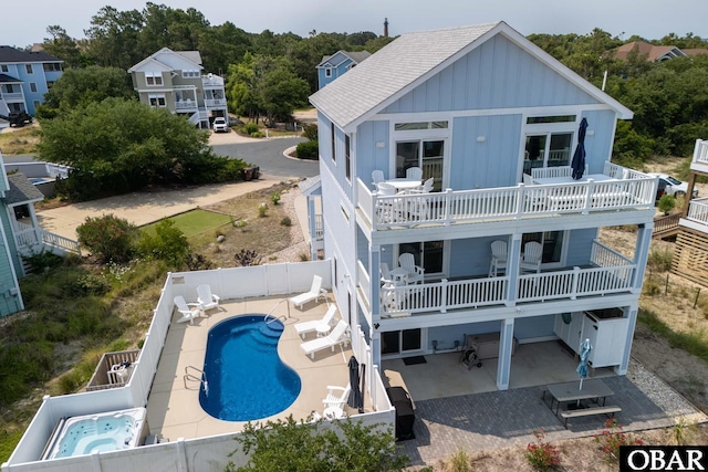 1206 Windance Ln Lot 103, Corolla, NC 27927 - back of house featuring board and batten siding, a fenced backyard, a patio area, and roof with shingles