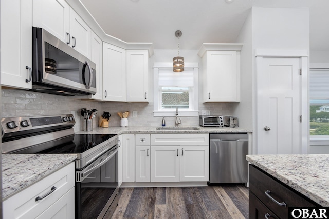 1206 Windance Ln Lot 103, Corolla, NC 27927 - kitchen with stainless steel appliances, a sink, dark wood-style flooring, white cabinets, and tasteful backsplash