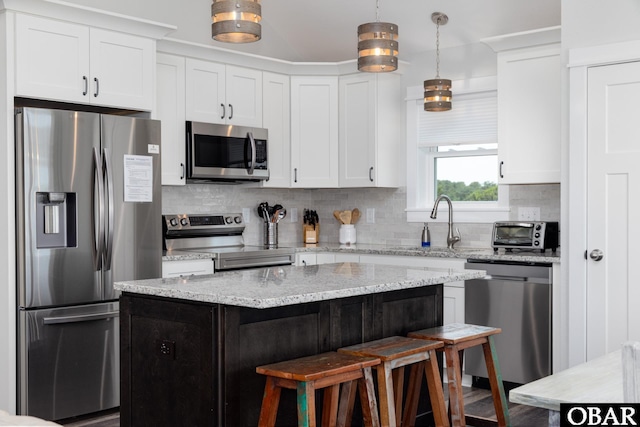 1206 Windance Ln Lot 103, Corolla, NC 27927 - kitchen featuring stainless steel appliances, a breakfast bar, backsplash, and a sink