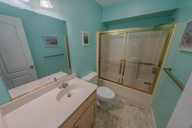 full bath with toilet, shower / bath combination with glass door, and vanity