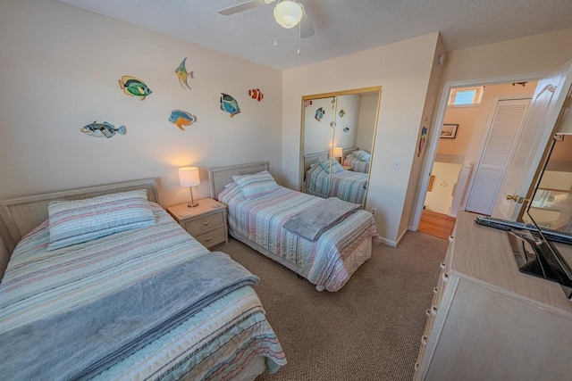 bedroom featuring carpet, a closet, a ceiling fan, and a textured ceiling