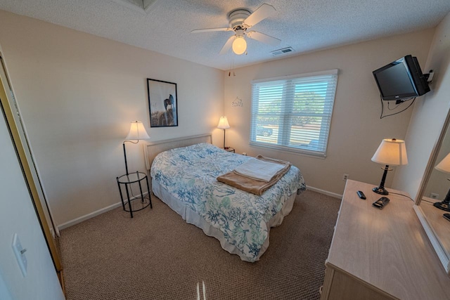 bedroom with baseboards, visible vents, a ceiling fan, light colored carpet, and a textured ceiling