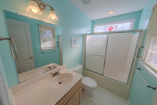 full bath featuring a textured ceiling, toilet, visible vents, combined bath / shower with glass door, and tile patterned floors